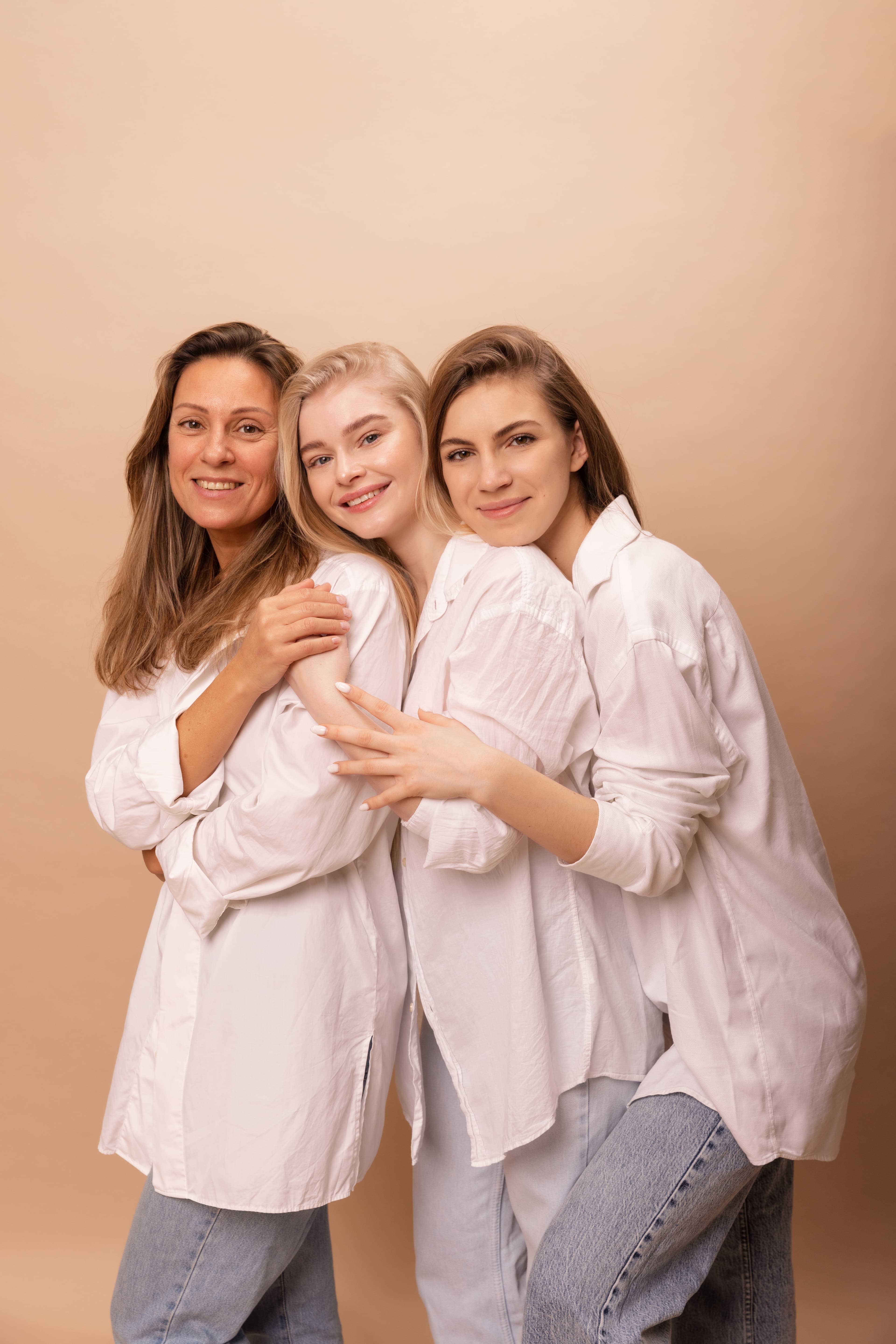 Three women of different ages smiling together